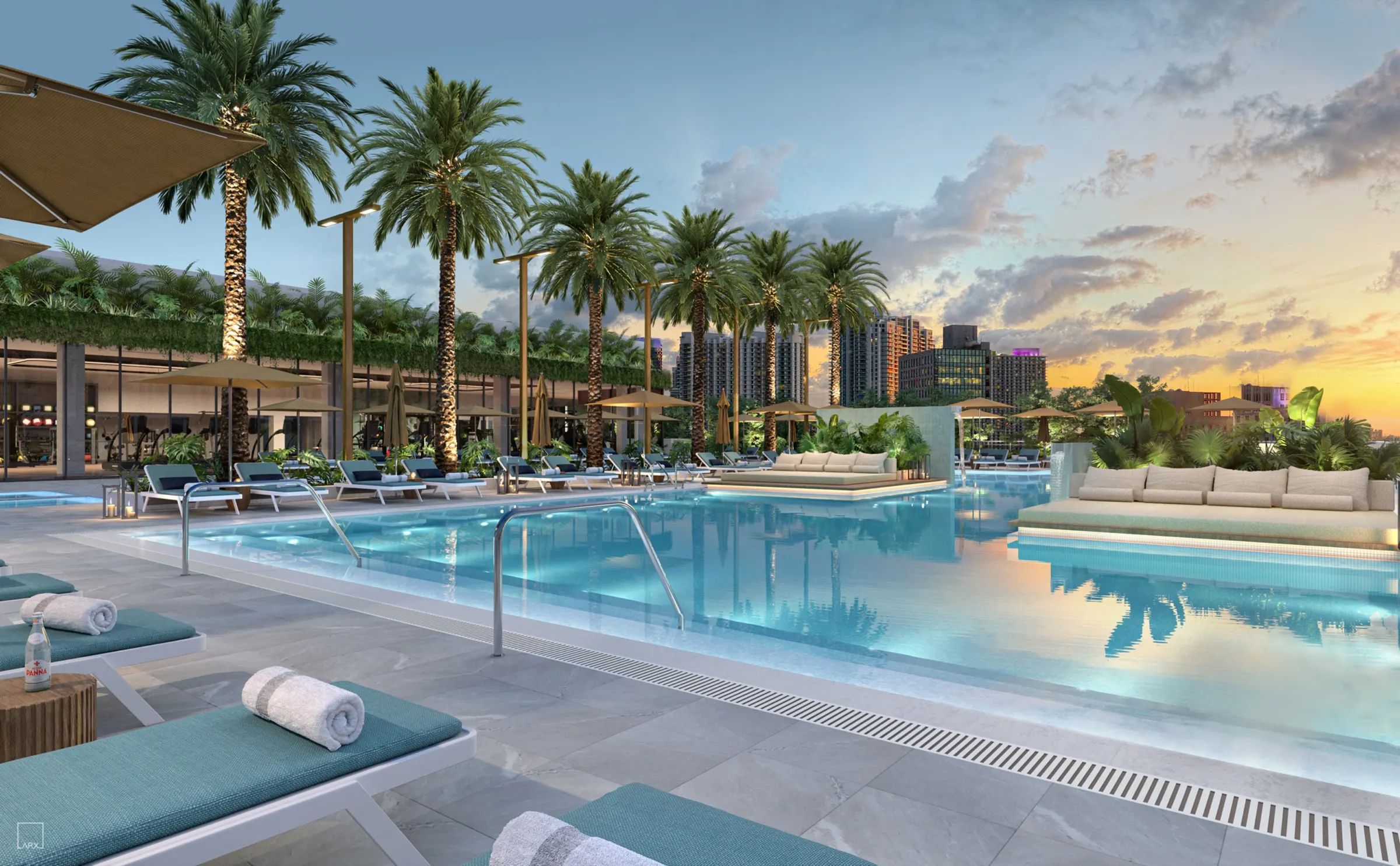 Resort-style pool deck with panoramic bay views at sunset